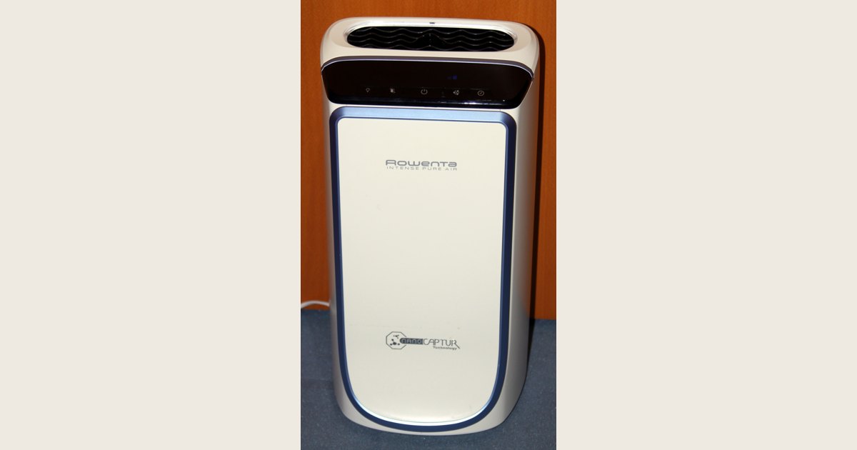 Portable air purifier with a smooth front panel and top controls