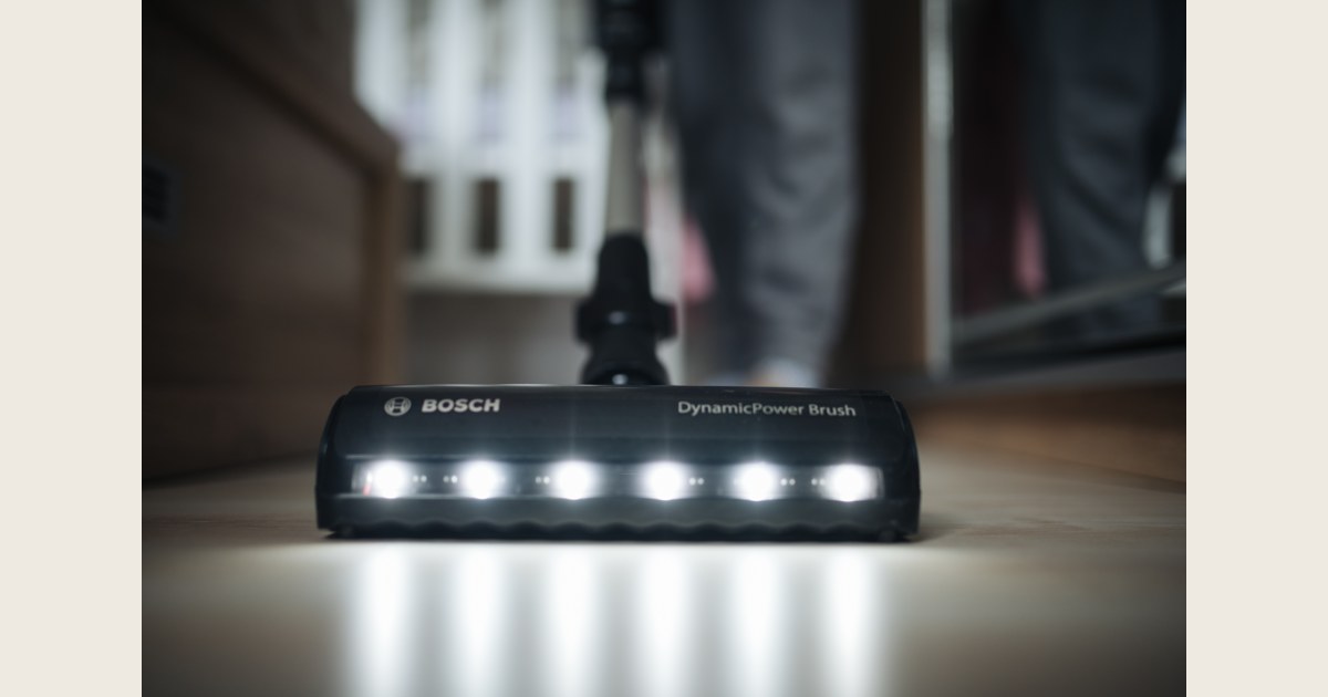 A vacuum floorhead with lights on a hard floor, illustrating the cleaning tool rather than a suction measurement