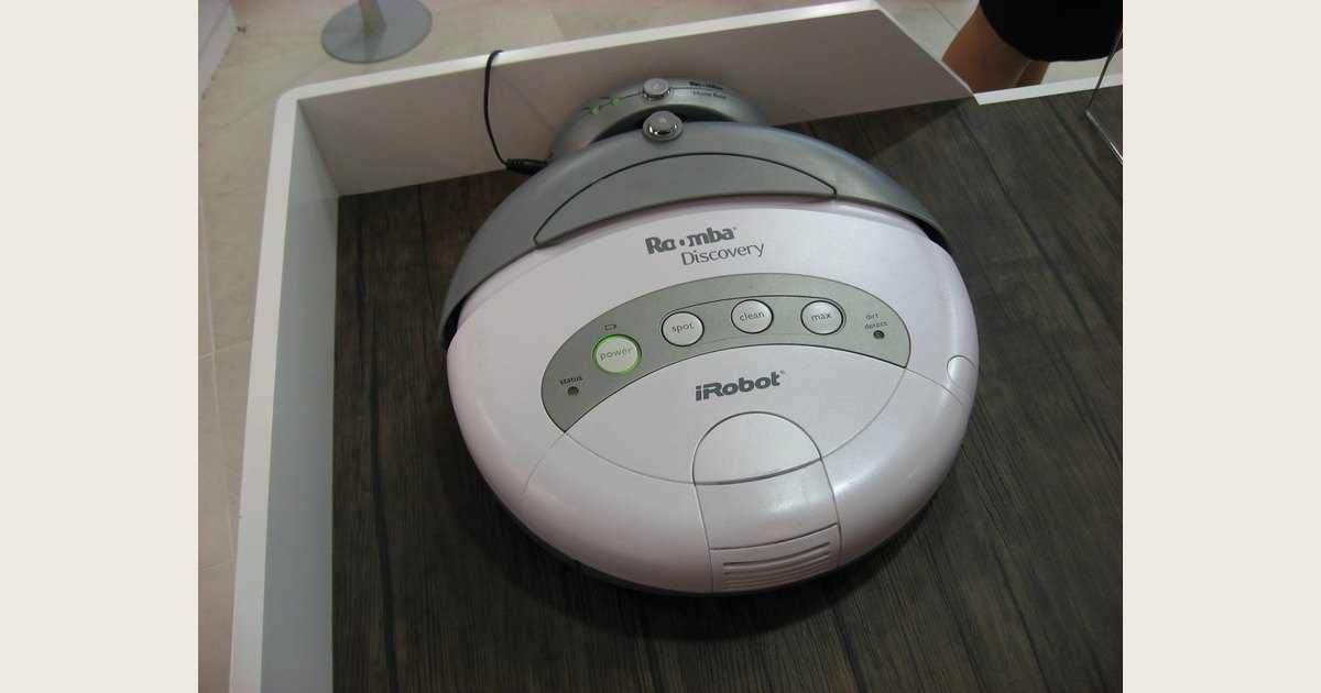 Illustrative stock image of a robot vacuum in a charging dock